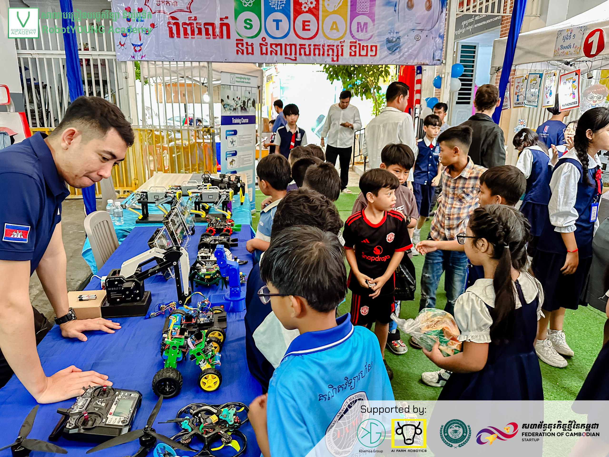 Children and adults gathered around a robotics demonstration at a public exhibition